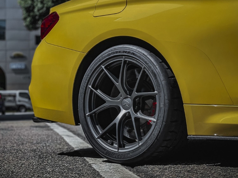 Performance car at a workshop with custom wheels